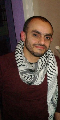 Photo of T.J. wearing a koufiyeh around his neck