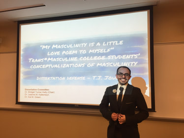 Picture of T.J. Jourian standing in front of a Powerpoint slide. The slide is the title of his dissertation defense (